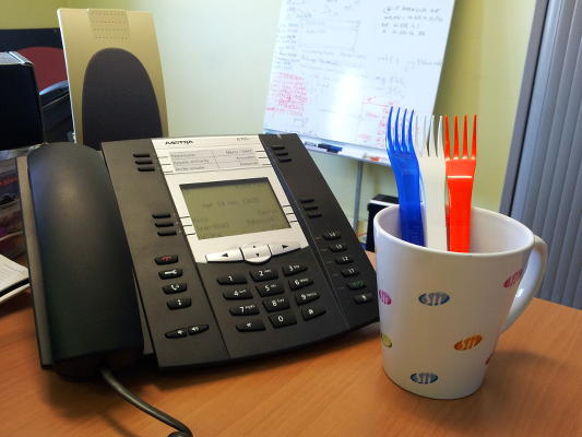 IP-Phone and french flag made of pasta-box forks at Orange Business Services